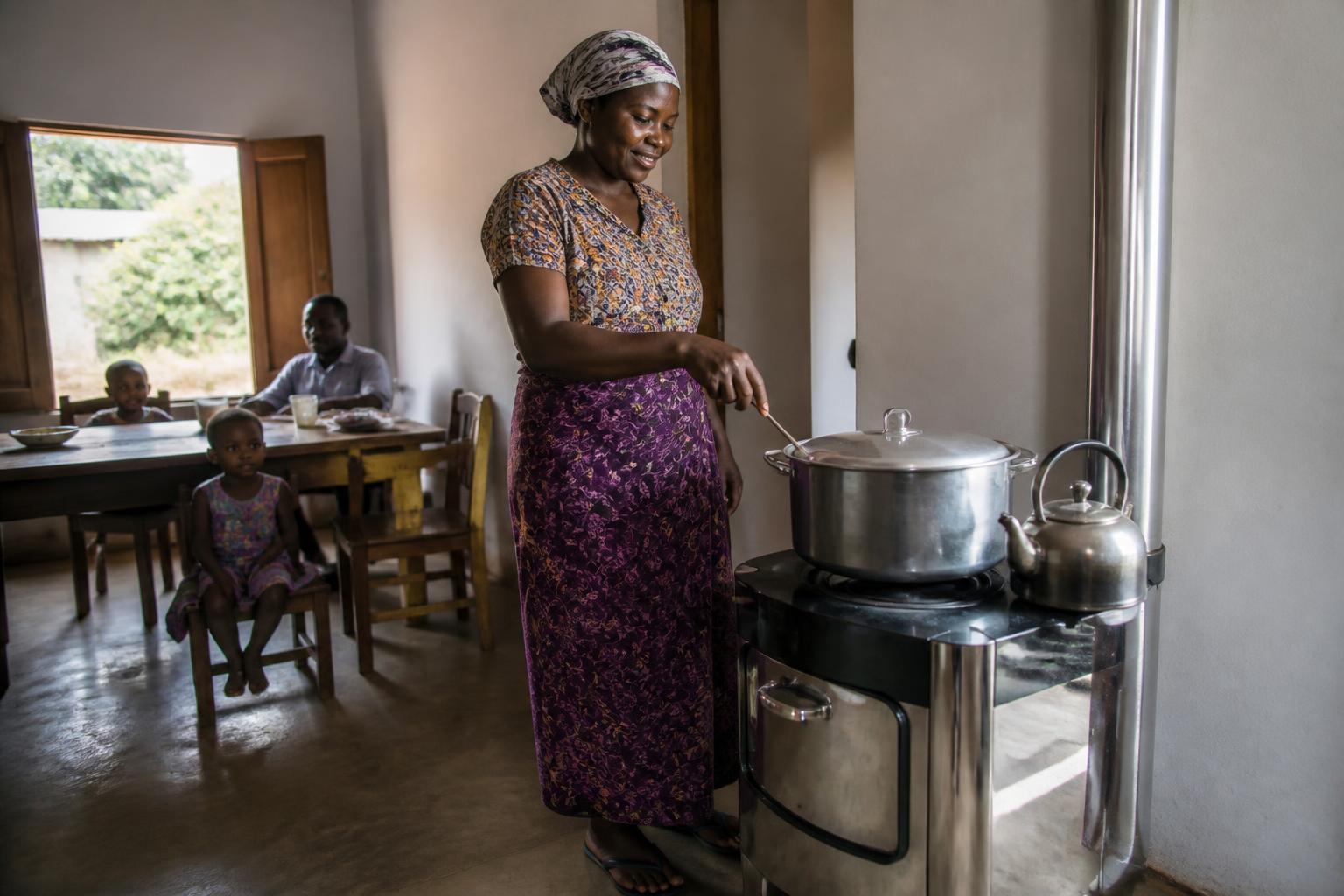 A Tanzanian woman using a modern clean cooking stove